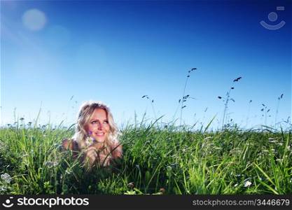 woman on green grass close up