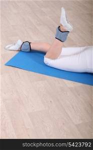 Woman on gym mat doing exercise