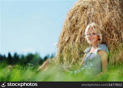 woman on hay nature background