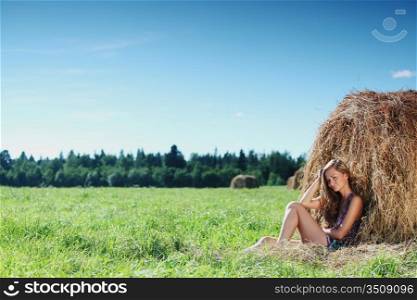 woman on hay nature background