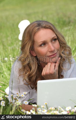 Woman on laptop in field