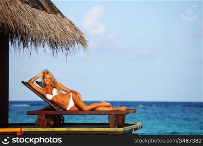 woman on lounge sea on background