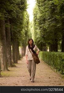 Woman on path between trees in Paris France