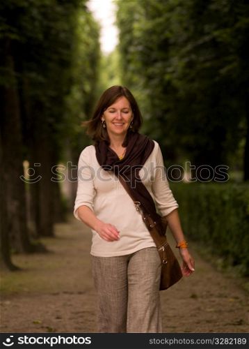 Woman on path between trees in Paris France