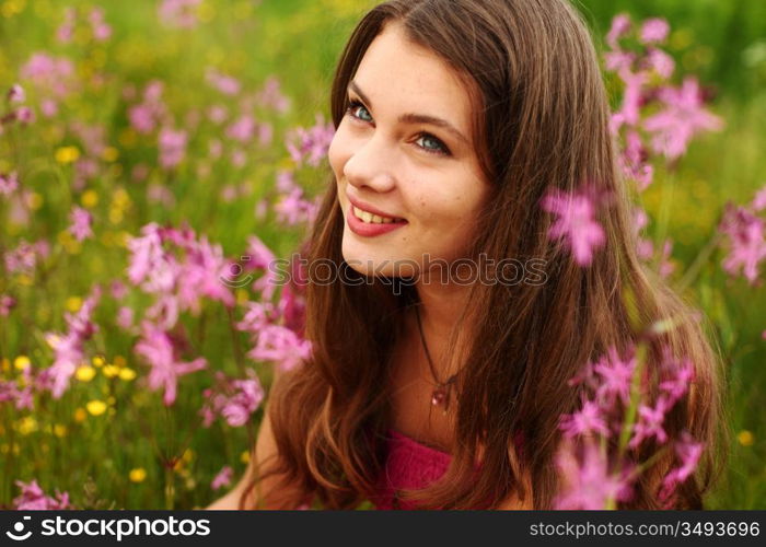 woman on pink flower field close portrait