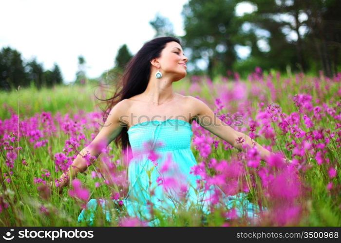 woman on pink flower field close portrait