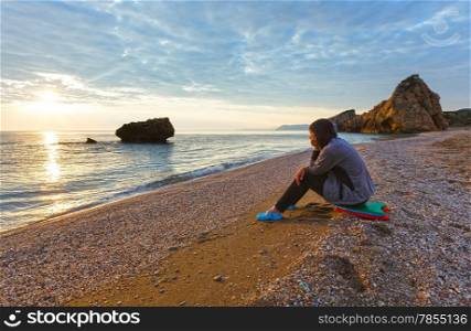 Woman on Potistika beach. Sunrise view (Greece). Aegean Sea.