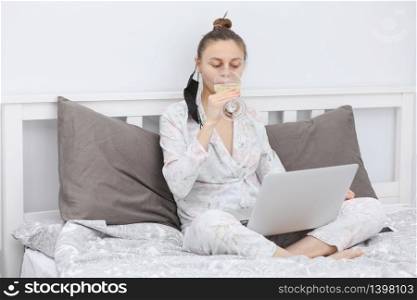 woman on self-isolation. Portrait of young happy woman using digital tablet while lying on bed at home and ordering food online or watching movie.. woman on self-isolation. Portrait of young happy woman using digital tablet while lying on bed at home and ordering food online or watching movie
