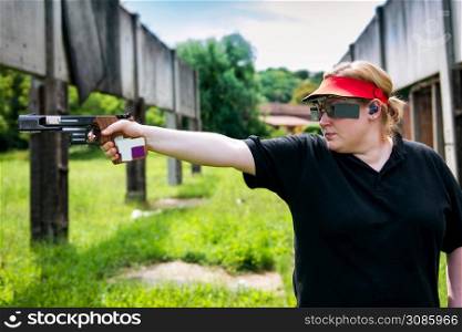 Woman on sport shooting training shooting target