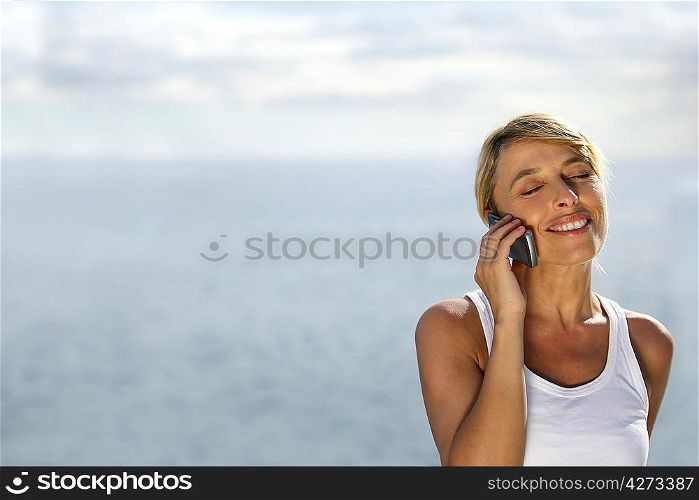 Woman on telephone at the beach
