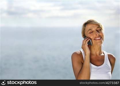 Woman on telephone at the beach