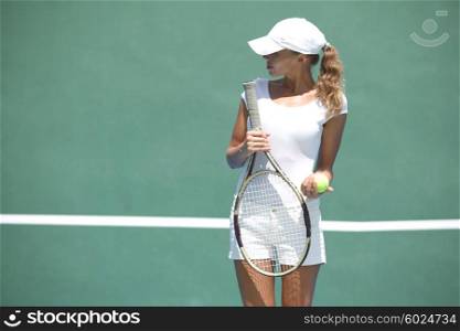 Woman on tennis court. Young woman in white sportswear on tennis court