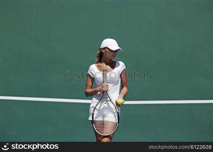 Woman on tennis court. Young woman in white sportswear on tennis court