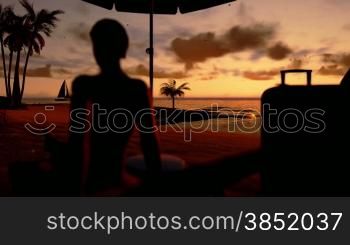 Woman on the beach, traveling suitcases and yacht sailing at sunrise