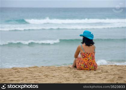 woman on the beach watching the horizon