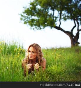 woman on the green grass under tree happy and smile