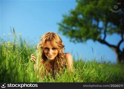 woman on the green grass under tree happy and smile