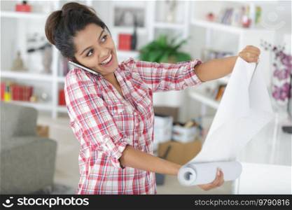 woman on the phone choosing wall paper