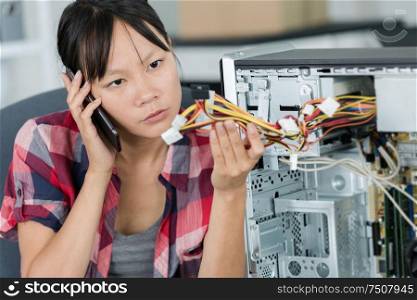 woman on the phone fixing pc