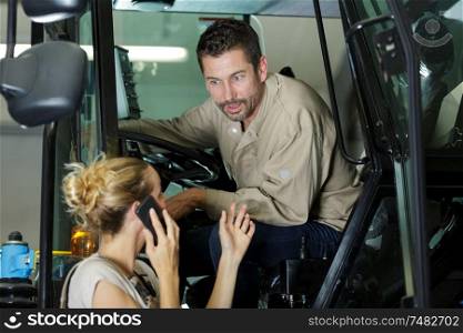 woman on the phone talking to forklift driver