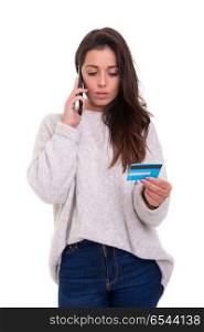 Woman on the phone using credit card. Beautiful woman at the phone using her credit card, isolated over white