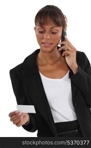 Woman on the phone watching business card