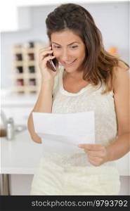 woman on the telephone imparting news received by letter