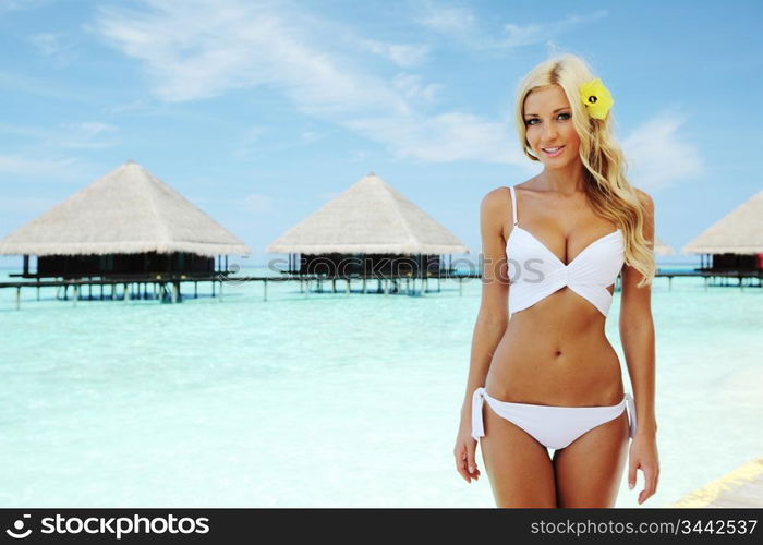 woman on tropical beach house back on the background