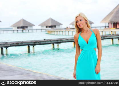 woman on tropical beach house back on the background