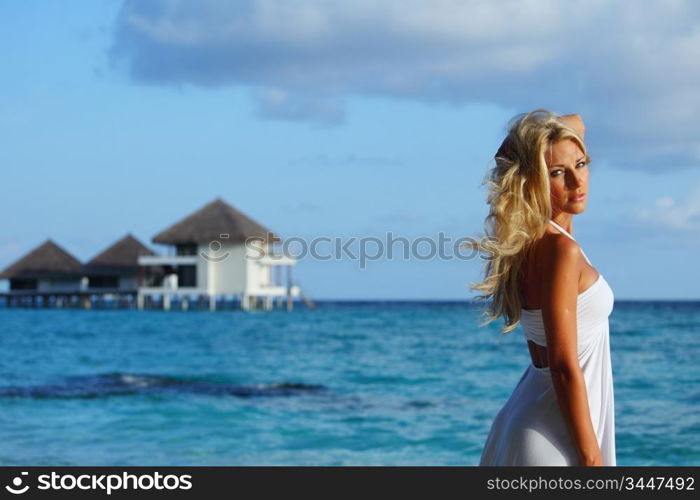 woman on tropical beach house back on the background