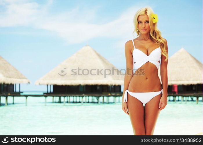 woman on tropical beach house back on the background