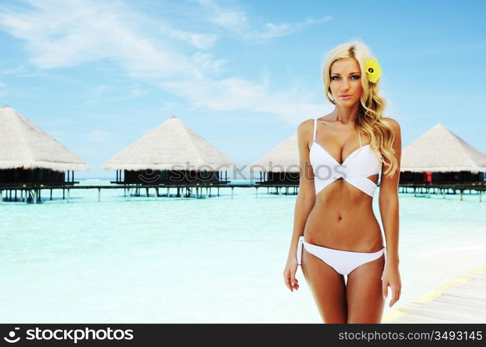 woman on tropical beach house back on the background