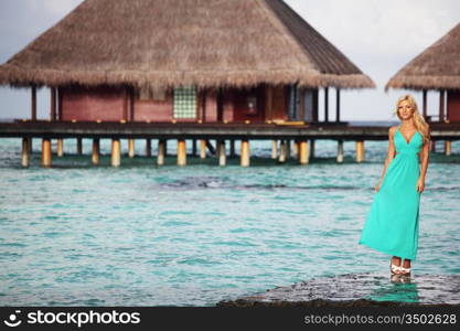 woman on tropical beach house back on the background