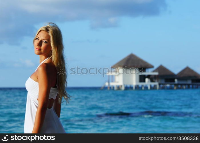 woman on tropical beach house back on the background