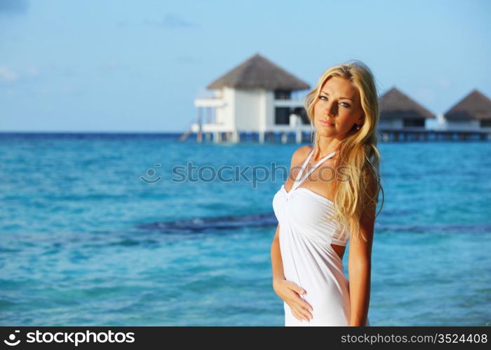 woman on tropical beach house back on the background