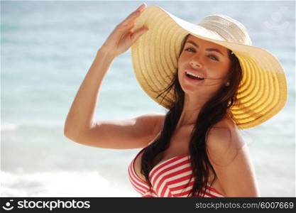 Woman on vacation. Portrait of a beautiful woman in sunhat on vacation