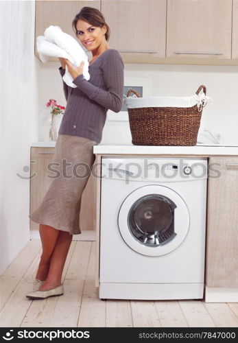 woman on washing machine in kitchen