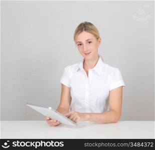Woman on white background using electronic tablet