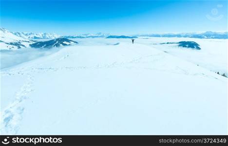 Woman on winter mountain Shneeberg top and view behind (Hochkoenig region, Austria)