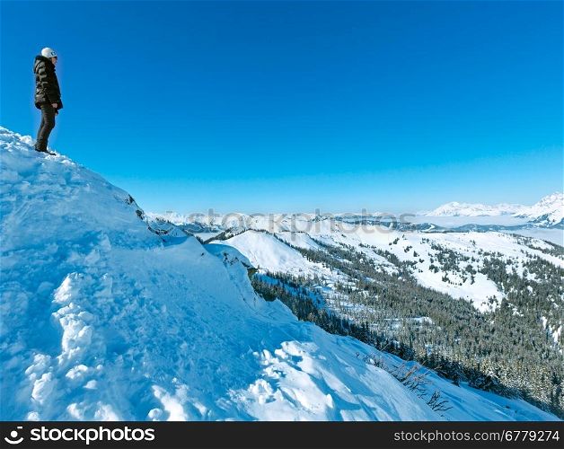 Woman on winter mountain Shneeberg top and view behind (Hochkoenig region, Austria)