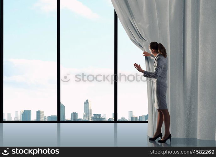 Woman open curtain. Businesswoman pulling curtain and cityscape behind it