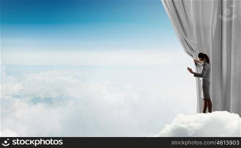 Woman open curtain. Young businesswoman opening stage curtain to another reality
