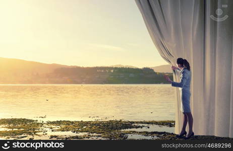 Woman open curtain. Young businesswoman opening stage curtain to another reality