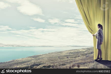 Woman open curtain. Young businesswoman opening stage curtain to another reality