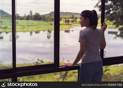 woman open window and looking to nature view