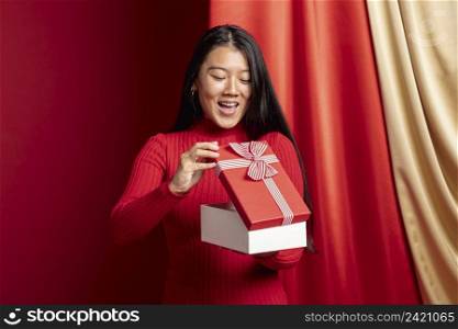 woman opening gift box chinese new year