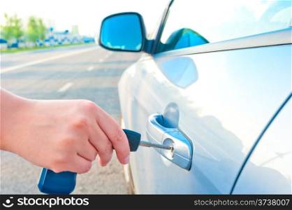woman opens a door key of a new car