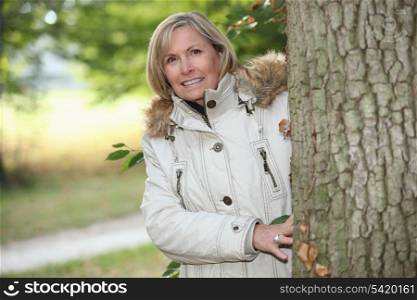 Woman out for an autumn stroll in the woods