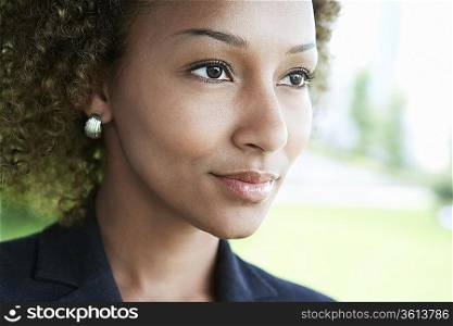 Woman outdoors looking away, close-up