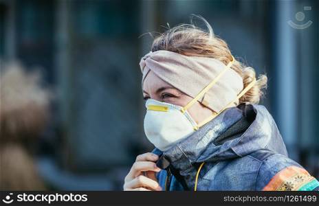 Woman outdoors with a breathing mask. Flue and corona season